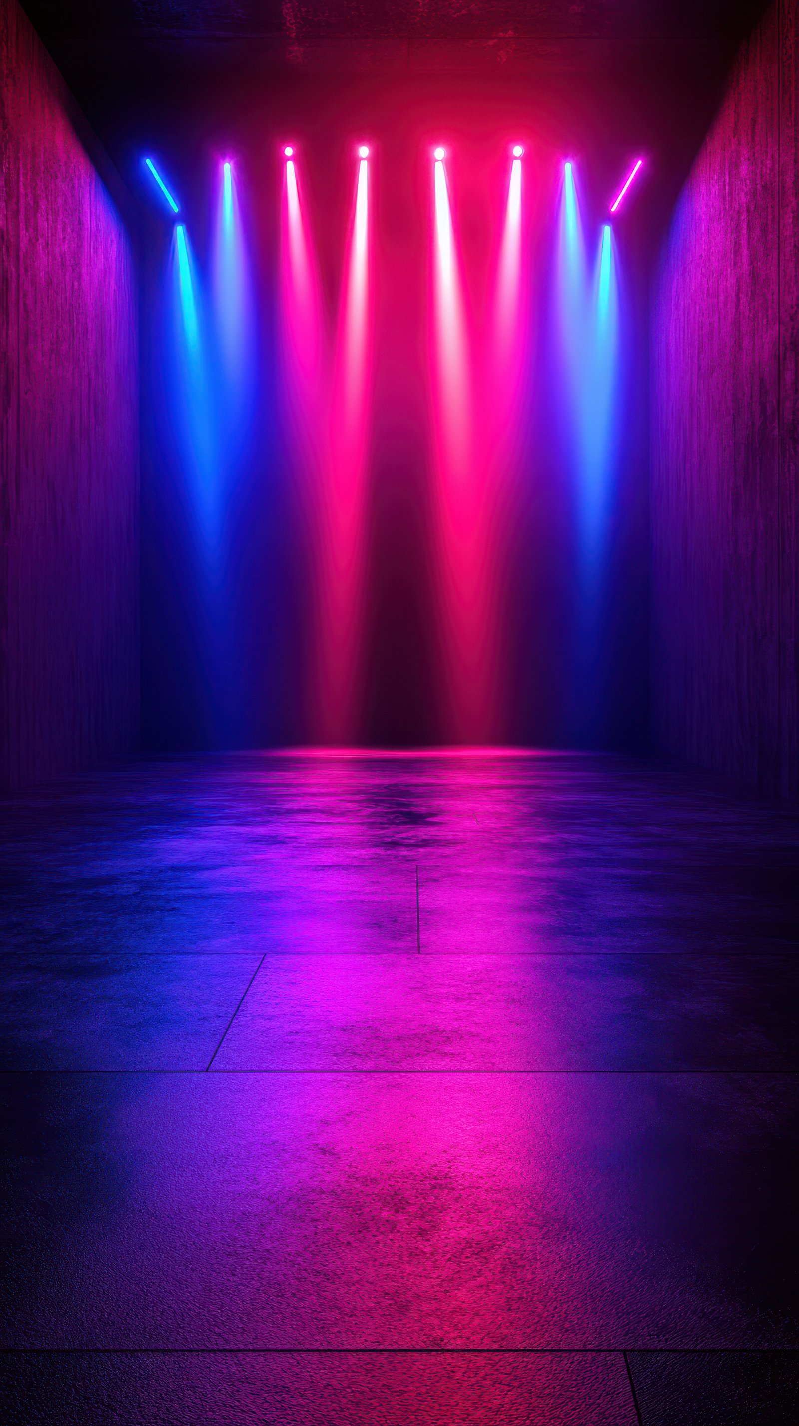 Colorful stage lights illuminate a modern performance space at night for an event filled with energy